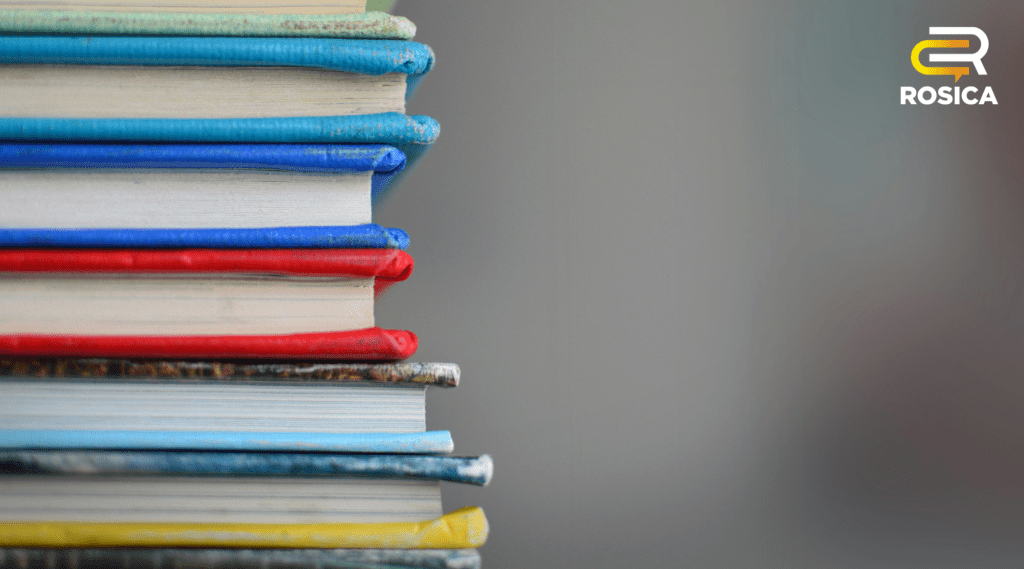 A stack of books in focus with a blurred background.